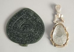 AN ISLAMIC ROCK CRYSTAL CALLIGRAPHIC DROP PENDANT, together with a carved jade calligraphic pendant,