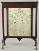 A CHINESE EMBROIDERED SILK PICTURE, framed within a hardwood fire screen, the embroidered image