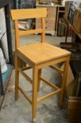 A pair of beech wood bar stools.