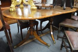 A twin pedestal dining table with two leaves.