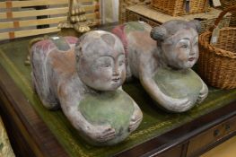 A pair of amusing carved wood seats modelled as Chinese children.
