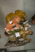 A carved hardstone model of a tiger and two others.