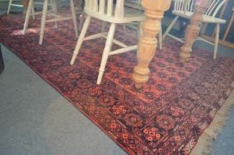 A Persian design rug, pink ground with numerous rows of floral palmettes, 290cms x 190cms.