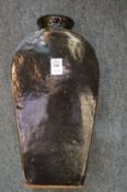 A black glazed slab sided pottery vase.