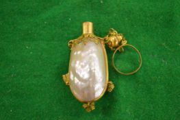A mother-of -pearl perfume bottle.