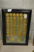 A collection of gilt metal medallions, framed and glazed.