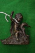 A small bronze group of a cherub on a swan.