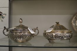 Two continental white metal bowls and covers with embossed decoration.