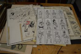 A collection of unframed cartoon artwork.