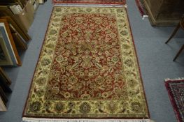 A burgundy ground floral decorated Persian style rug, 185cms x 123cms.