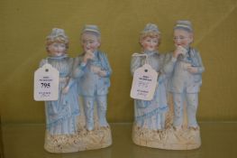 A pair of bisque figure groups.