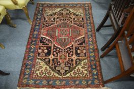A Persian rug with stylized and floral decoration, 152cms x 105cms.