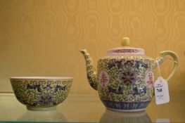 A Chinese Famille Jaune teapot and bowl.