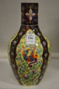 An enamelled decorated opaque glass bottle vase.
