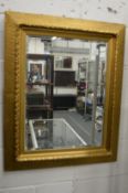 A decorative gilt framed mirror.