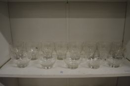 A set of eight engraved glass goblets and five engraved glass bowls.