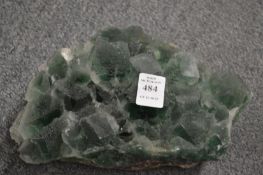 A green crystal mineral sample.
