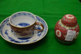 A Chinese cup and saucer and a small ginger jar.