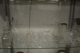 A shelf of good cut-glass and other glassware to include decanters, jugs, wine glasses etc.