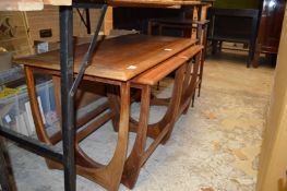 A teak nest of tables and an occasional table.