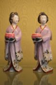 A pair of Kutani figures of a woman holding a bowl.