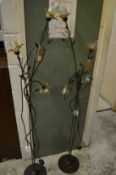 A pair of naturalistic style floor standing lamps.