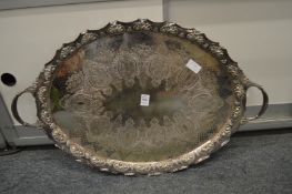 A plated oval twin handled tray with engraved decoration.