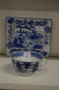 A Chinese blue and white tea cup and a small blue and white dish.