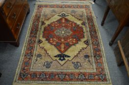 A beige ground Persian style rug, 185cms x 125cms.