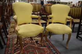 A pair of carved giltwood framed and upholstered open armchairs.