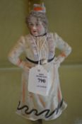 A bisque porcelain figure of a woman.