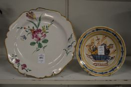 A tin glazed dish painted with flowers and another smaller dish.