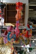A colourful glass five branch chandelier.