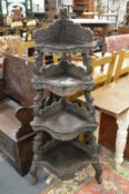 A Ceylonese hardwood four-tier corner what-not with carved and pierced decoration.