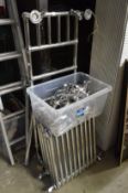 A chrome Victorian style towel rail, two radiators and ancillary equipment including mixer taps.