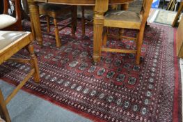 A large red ground Bokhara style carpet, 300cms x 260cms.