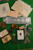 A metal cash box containing coins and miscellaneous collectables.