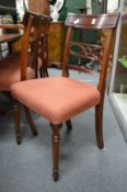 A set of four reproduction mahogany dining chairs.