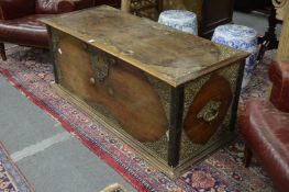 An eastern teak trunk with pierced brass decoration and brass carrying handles.