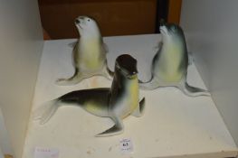 Three Royal Dux sealions.