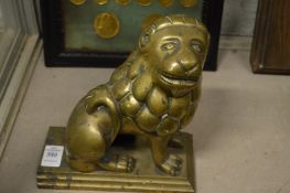 A bronze model of a lion.