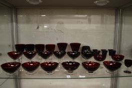 A quantity of ruby glass wine goblets and other items.