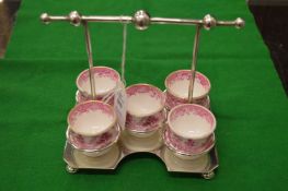 A plated egg cruet containing five Spode porcelain egg cups.