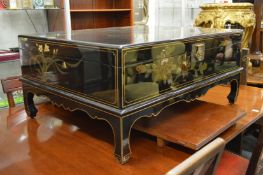 A good Chinese black lacquer and decorated storage box / coffee table.