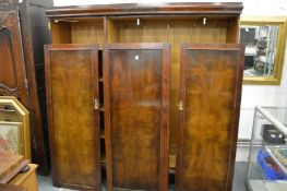 A mahogany four-door wardrobe.
