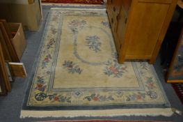 A Chinese rug, beige ground with floral decoration, 210cms x 138cms.
