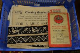 A small embroidered strip of fabric, a map and other ephemera.