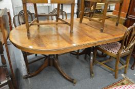 A twin pedestal mahogany dining table with one leaf.