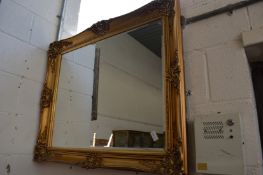 A Victorian style gilt framed rectangular wall mirror.