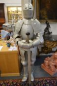 A reproduction life size suit of armour, complete with sword.